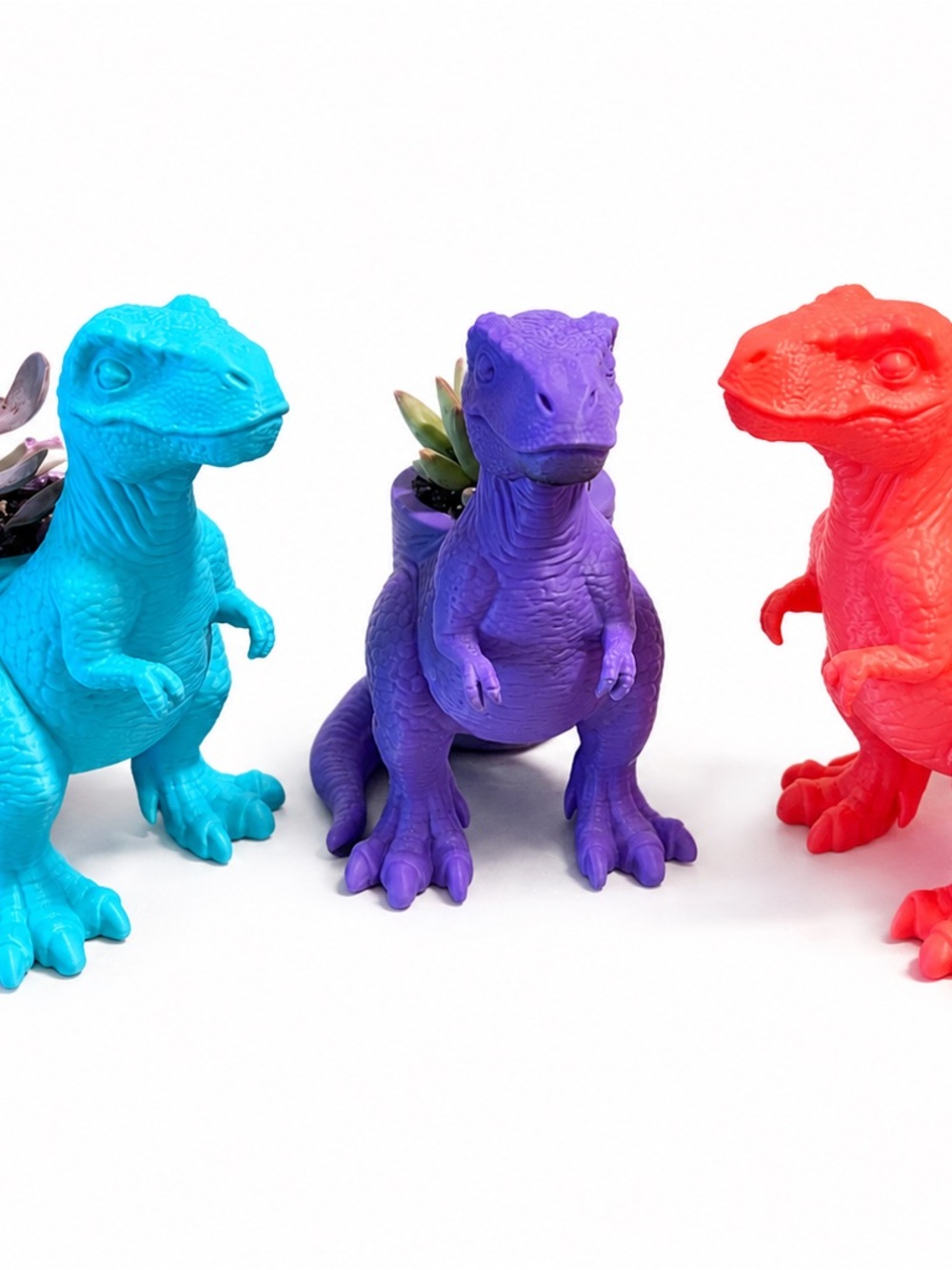 A trio of dinosaur planters